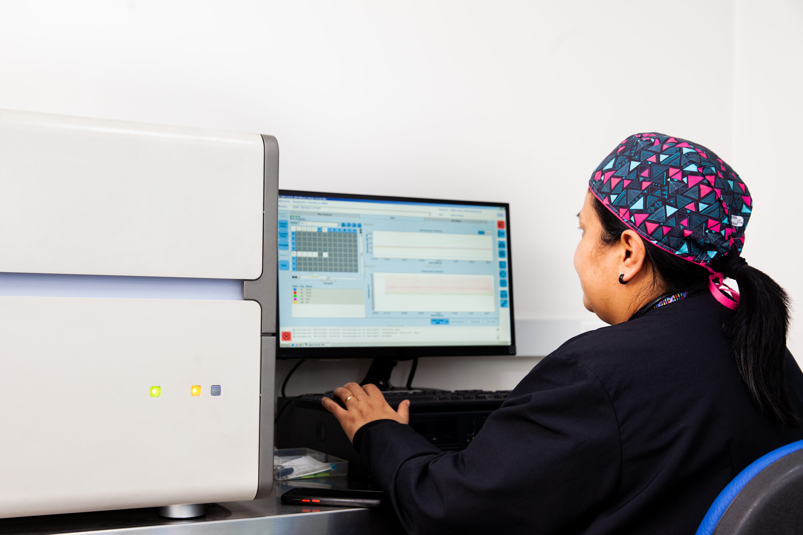 female scientist working at the laboratory with a thermal cycler