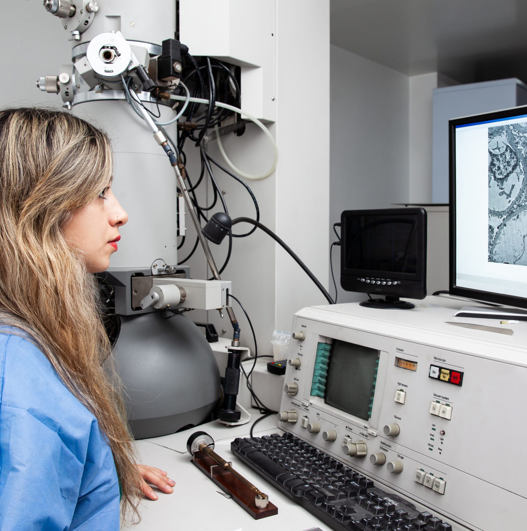 young female scientist working at the laboratory with an electro