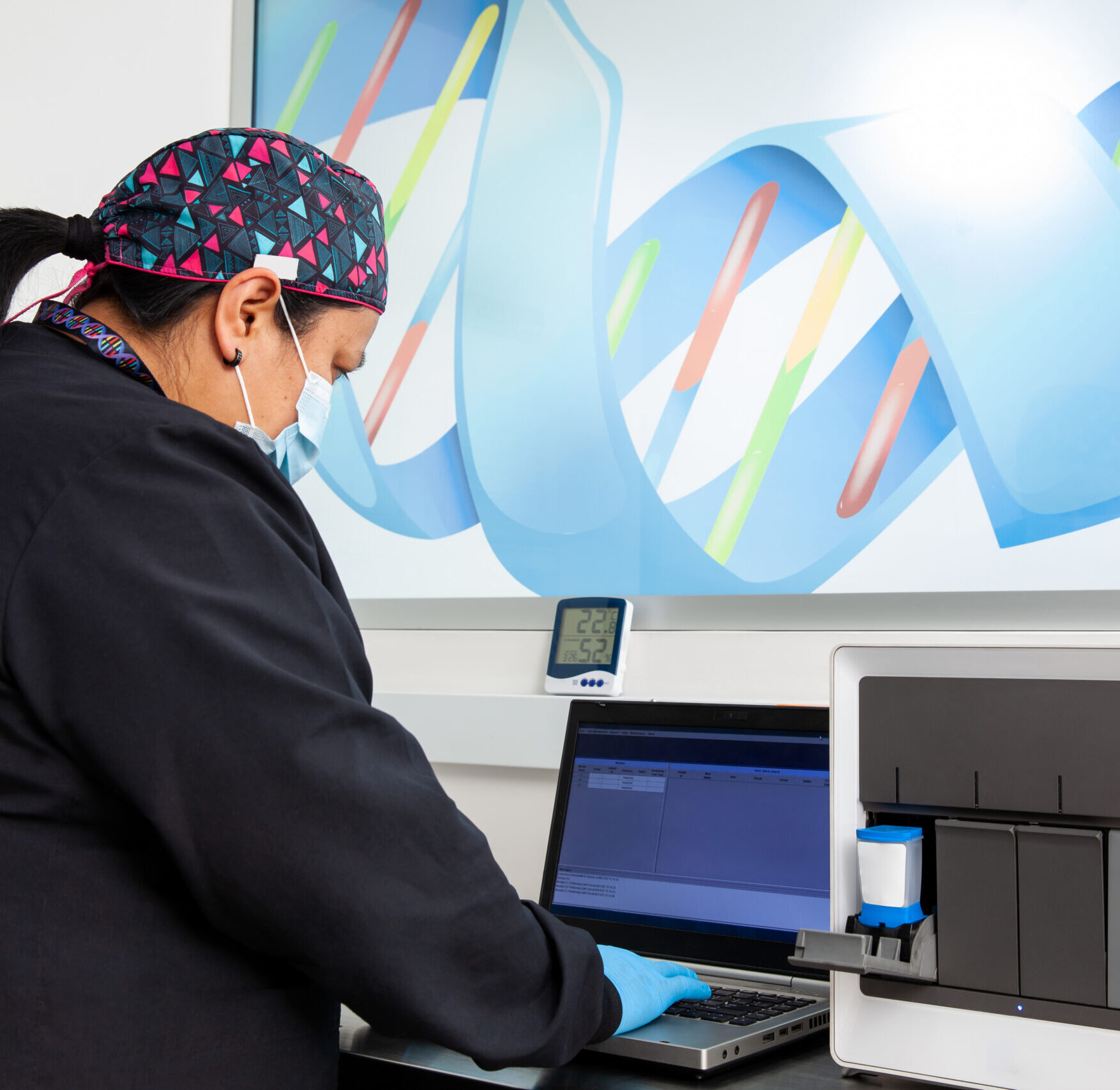female scientist working at the laboratory with a thermal cycler